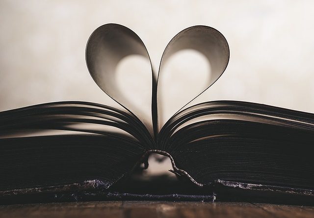 book open with pages folded over shaped like heart